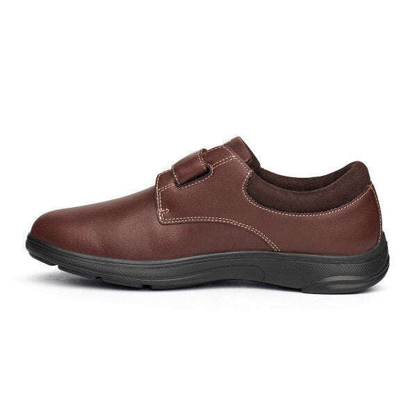 Side profile of the Anodyne No. 64 diabetic shoe in whiskey brown, showcasing its sleek leather finish, single strap closure, and supportive black outsole.