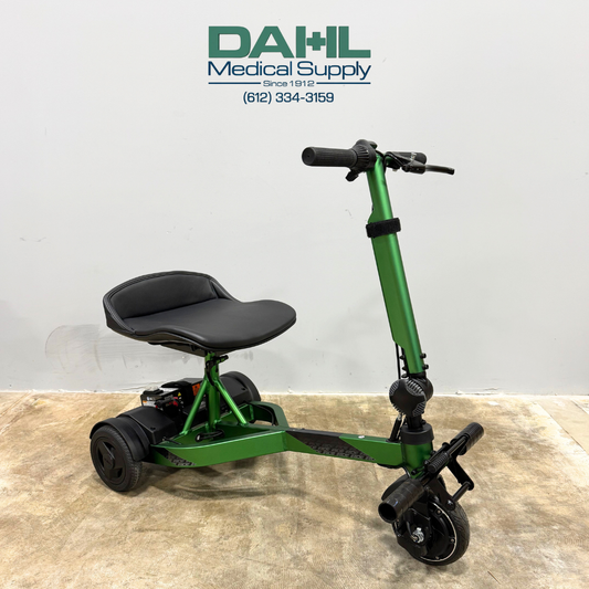 Angled view of a used Drive iRIDE S25 3-wheel mobility scooter with padded seat, adjustable tiller, and compact travel-friendly frame.