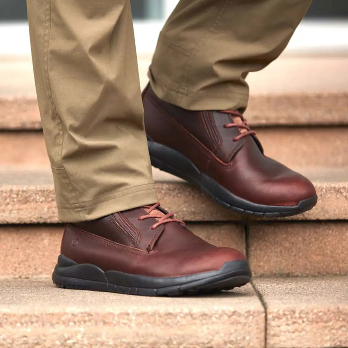 Man wearing brown leather men’s diabetic boots with slip-resistant soles, designed for comfort, circulation support, and diabetic foot protection – available at Dahl Medical Supply.
