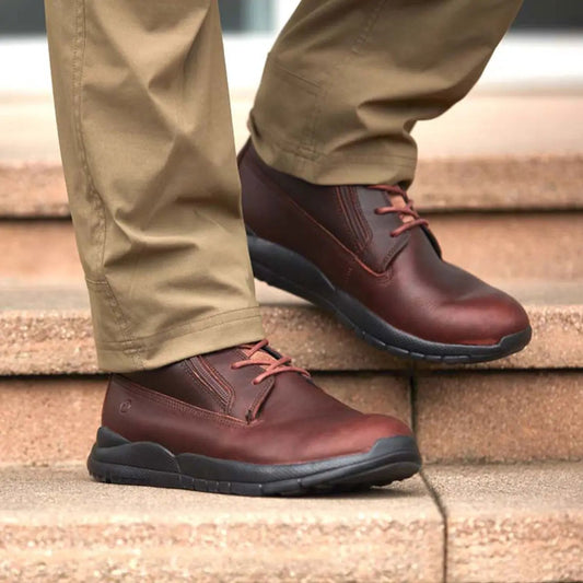 Man wearing brown leather men’s diabetic boots with slip-resistant soles, designed for comfort, circulation support, and diabetic foot protection – available at Dahl Medical Supply.
