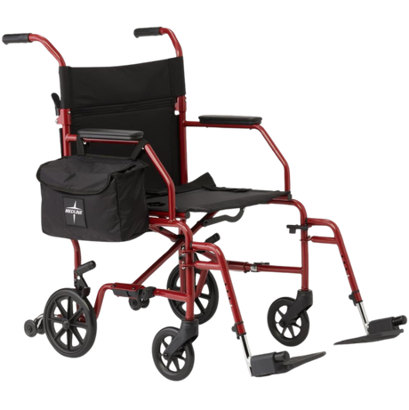 Medline red lightweight steel transport wheelchair with black seat, footrests, and side storage bag—available at Dahl Medical Supply in Burnsville, Minnesota, serving the Twin Cities area.