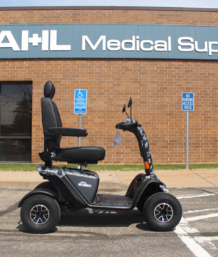Baja Wrangler® 2 four-wheel mobility scooter parked outside Dahl Medical Supply storefront