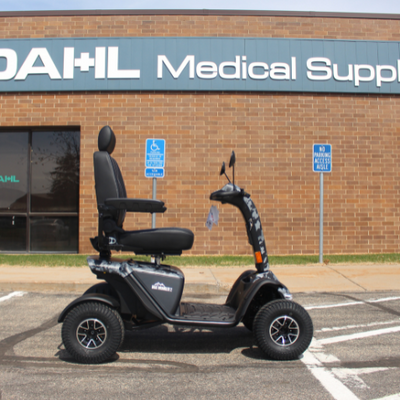 Baja Wrangler® 2 four-wheel mobility scooter parked outside Dahl Medical Supply storefront
