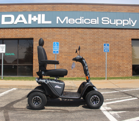 Baja Wrangler® 2 four-wheel mobility scooter parked outside Dahl Medical Supply storefront