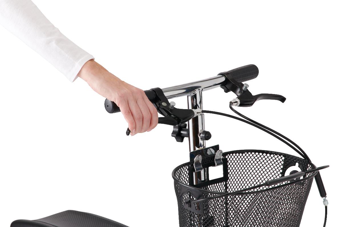 Close-up view of a person’s hand using the dual handbrakes on the Medline Generation 4 knee walker, showing easy-to-grip handles and control levers above the front basket.