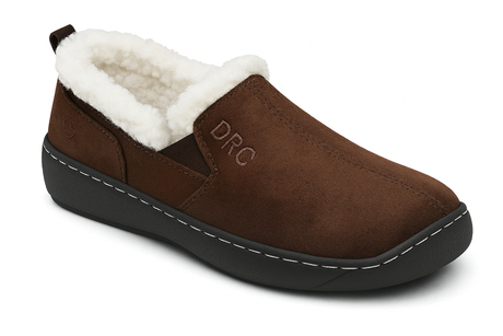 Side view of the Dr. Comfort Men's Vista Slipper in Chocolate, showcasing its soft suede-like exterior, plush white fleece lining, and durable black outsole.