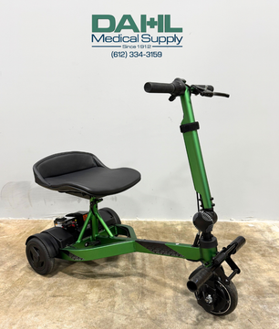 Angled view of a used Drive iRIDE S25 3-wheel mobility scooter with padded seat, adjustable tiller, and compact travel-friendly frame.