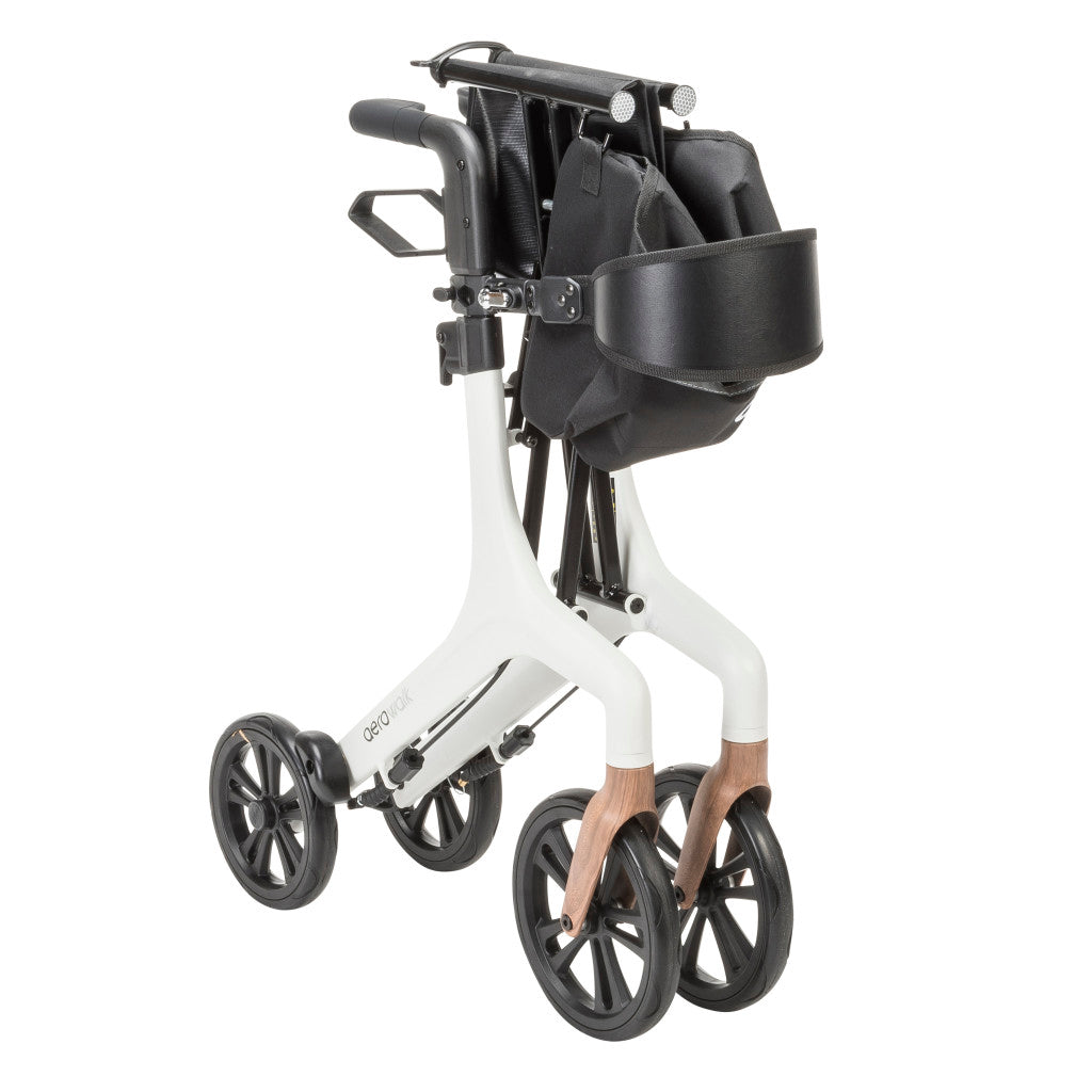 Folded AeroWalk Ultra-Lite Rollator Walker in white showing compact storage design, lightweight aluminum frame, and large wheels