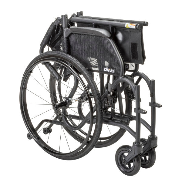 Folded AeroFly Ultra Lite Wheelchair showing compact aluminum frame, quick-release wheels, and lightweight travel design.