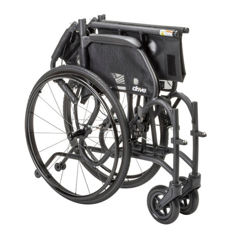 Folded AeroFly Ultra Lite Wheelchair showing compact aluminum frame, quick-release wheels, and lightweight travel design.