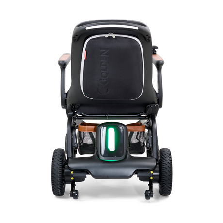 Rear view of the Golden Ally GP303 portable power wheelchair featuring the illuminated rear safety light, all-terrain wheels, backrest storage pocket, and sturdy frame design.
