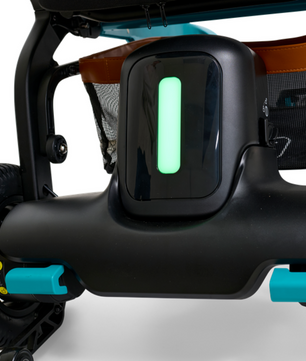 Close-up view of the Golden Ally GP303 power wheelchair showing the illuminated rear light indicator, teal accents, and durable rear wheel assembly.