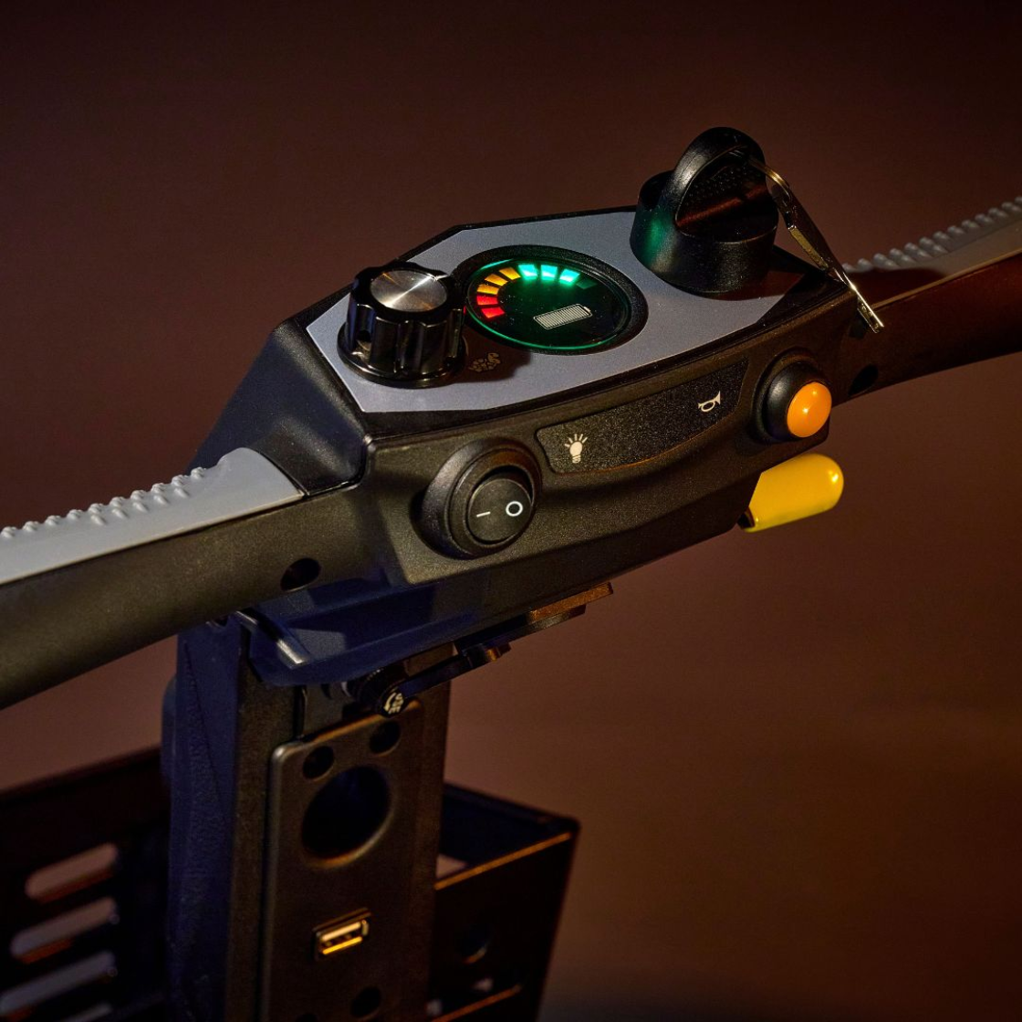 Close-up of the Golden Buzzaround CarryOn GB120 scooter control panel and tiller.