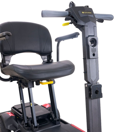 Front close-up of the Golden Buzzaround CarryOn GB120 scooter seat and steering controls.