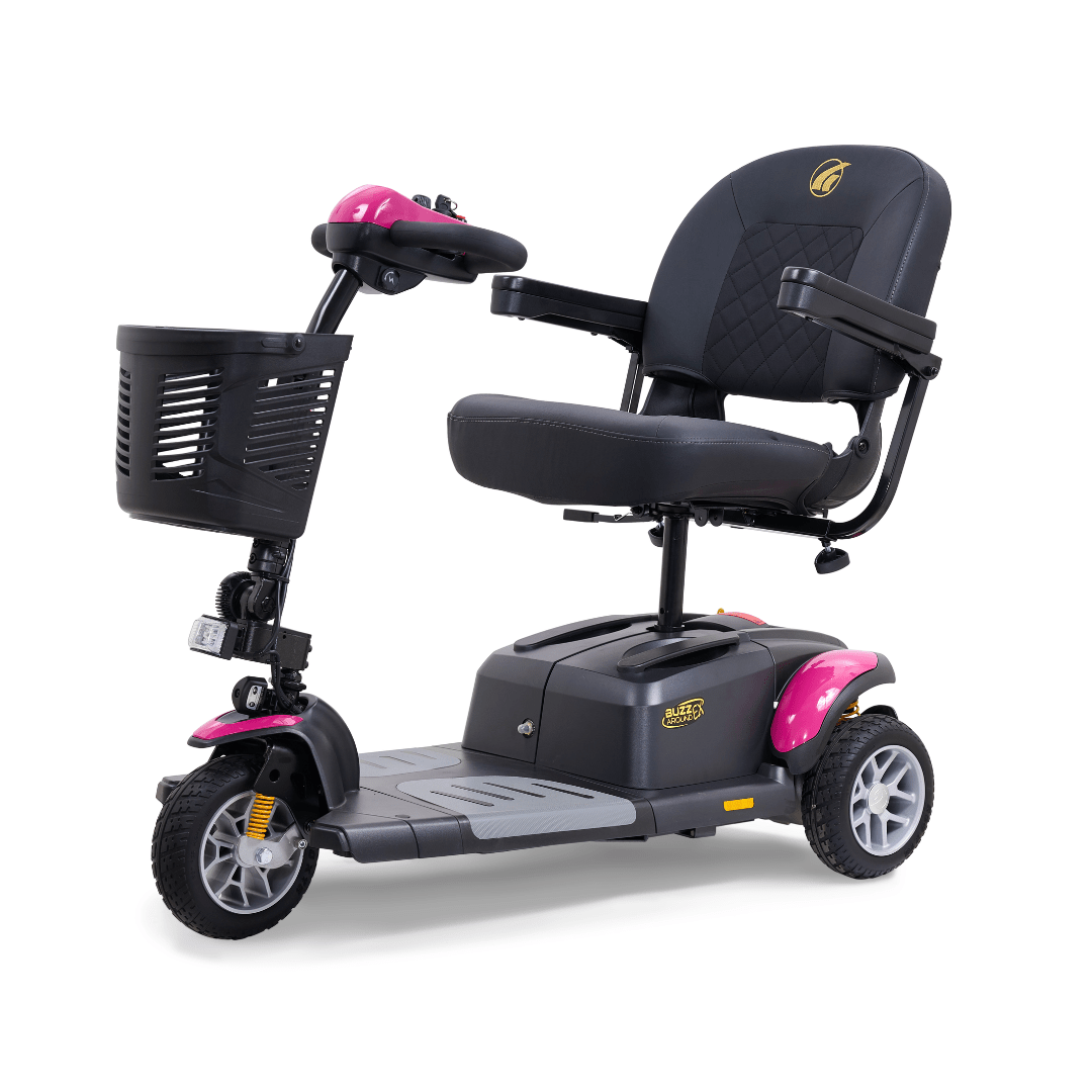 Golden Buzzaround EX 3-wheel mobility scooter with pink accents, padded seat, armrests, front basket, and compact three-wheel design
