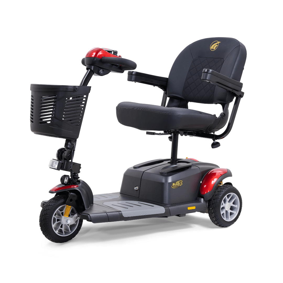 Golden Buzzaround EX 3-wheel mobility scooter with red accents, padded seat, armrests, front basket, and compact three-wheel design