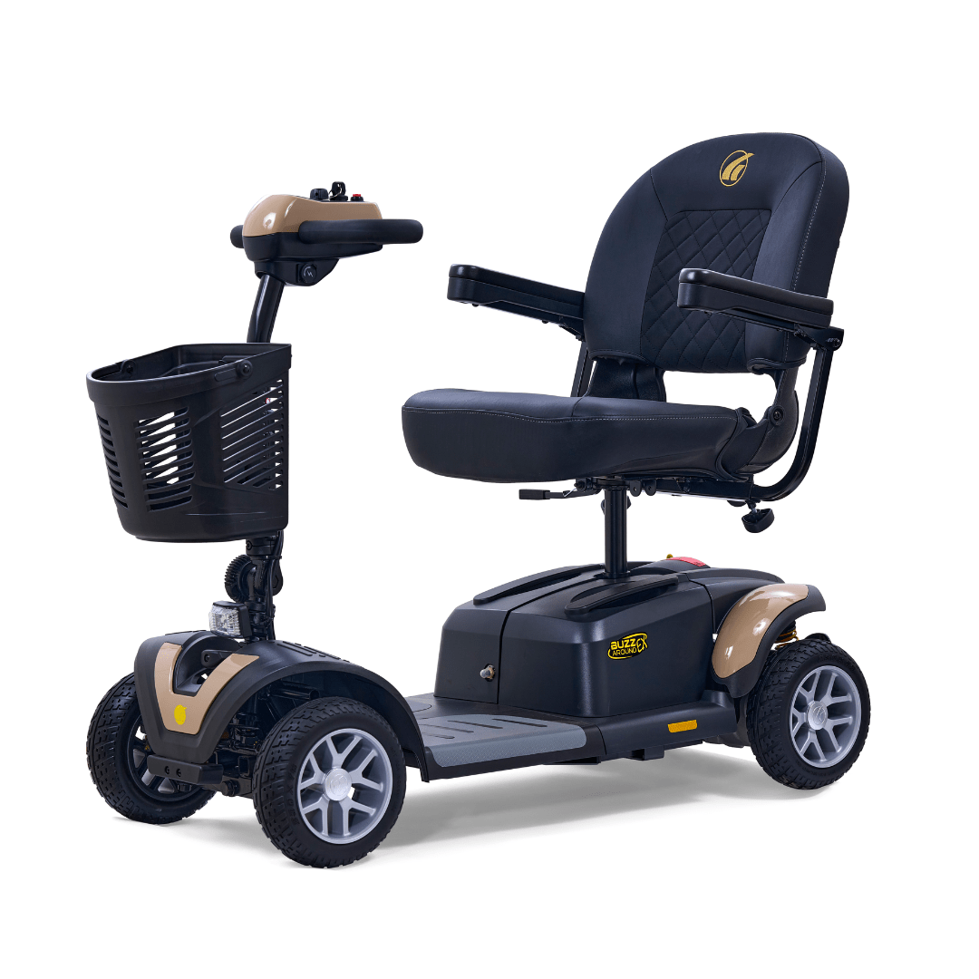 Golden Buzzaround EX 4-wheel mobility scooter with tan accent panels, padded seat, front basket, and four wheels on a white background