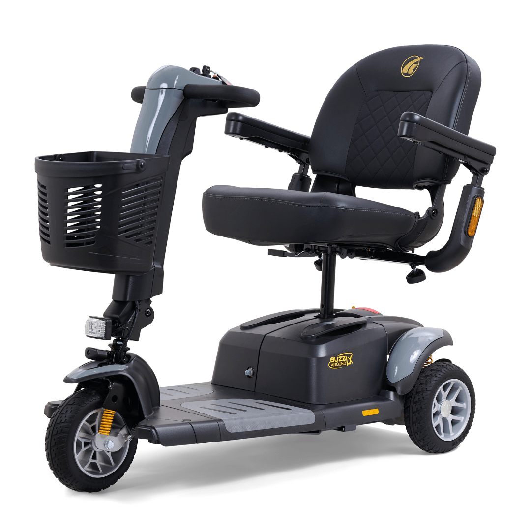 Gray Golden Buzzaround LX 3-wheel mobility scooter shown with padded seating, armrests, front basket, and stable three-wheel configuration.