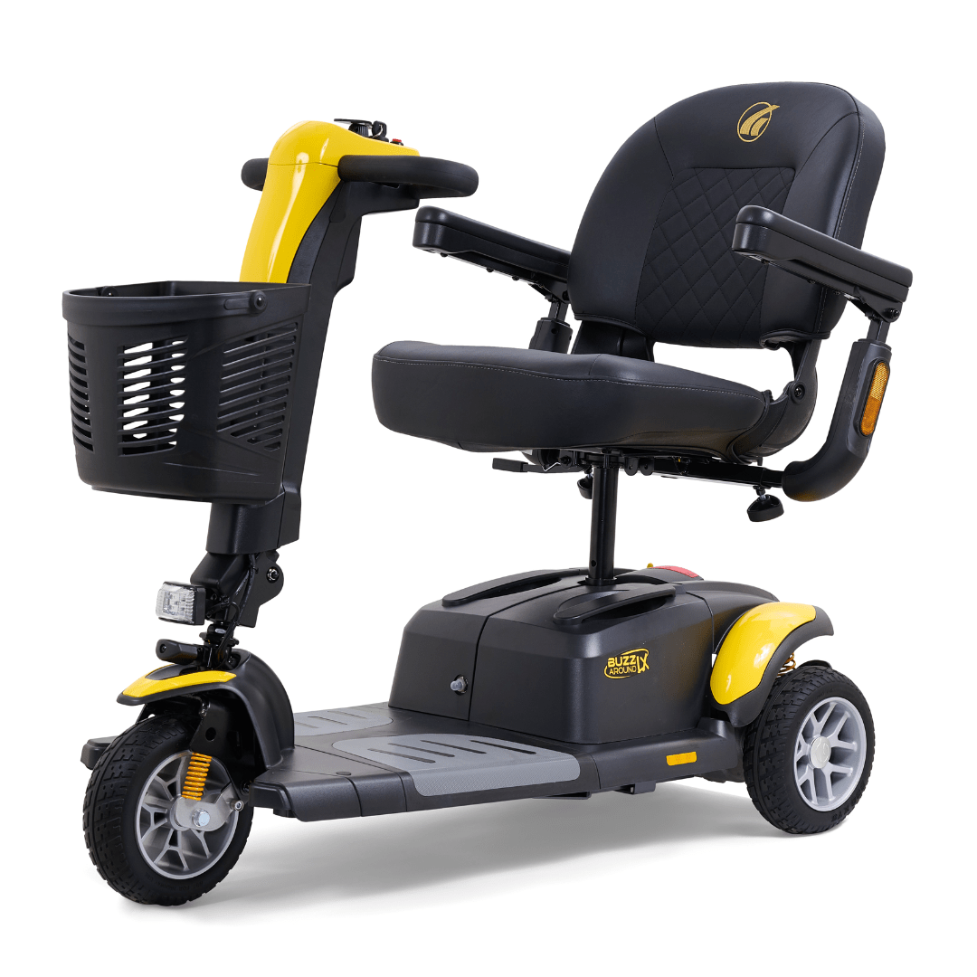 Yellow Golden Buzzaround LX 3-wheel mobility scooter shown with padded seat, armrests, front basket, and three-wheel configuration.