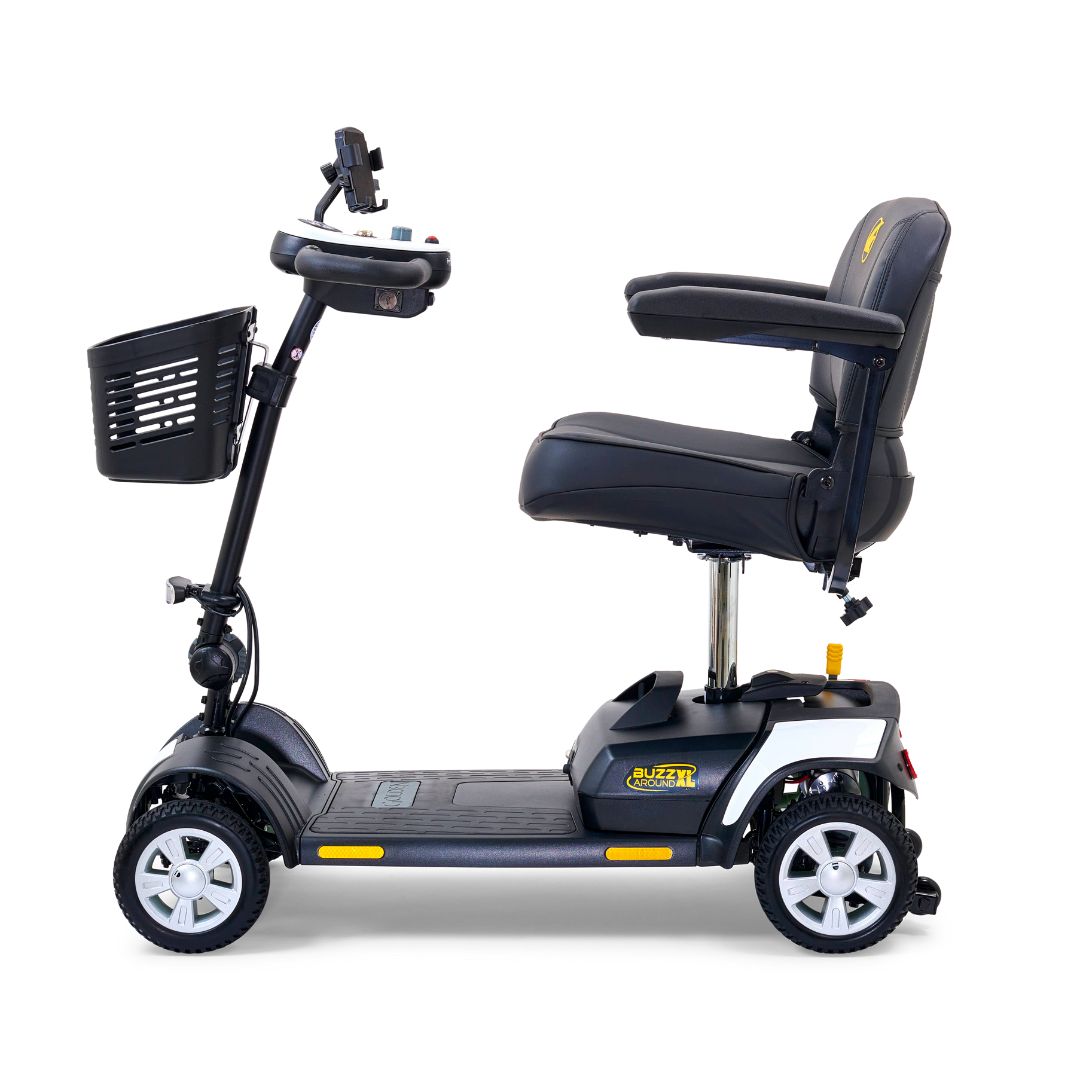 Side view of the Golden Buzzaround XL 4-wheel mobility scooter showing padded seat, armrests, front basket, and four-wheel base.