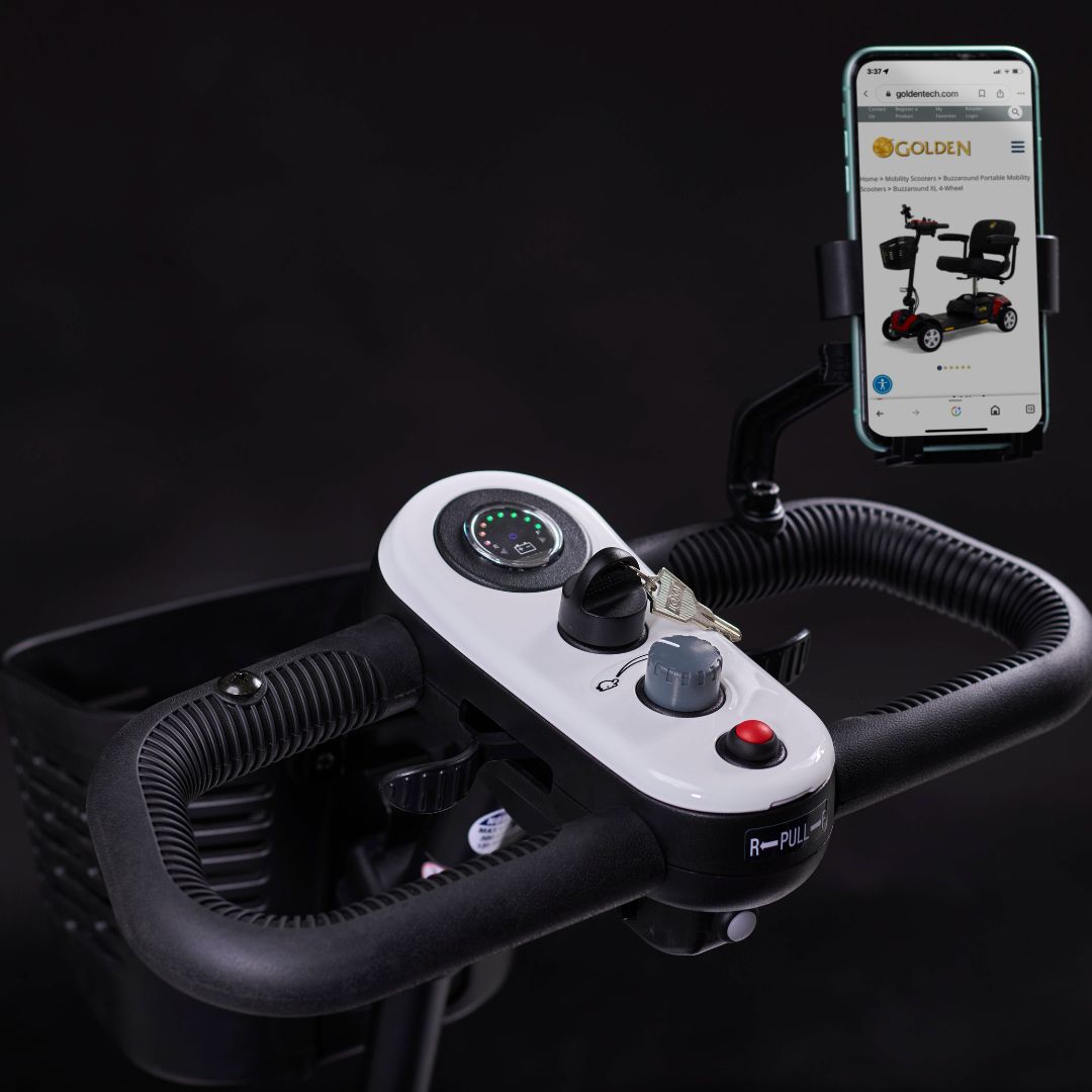 Close-up of the Golden Buzzaround XL mobility scooter control panel with speed dial, battery indicator, key switch, and phone holder.