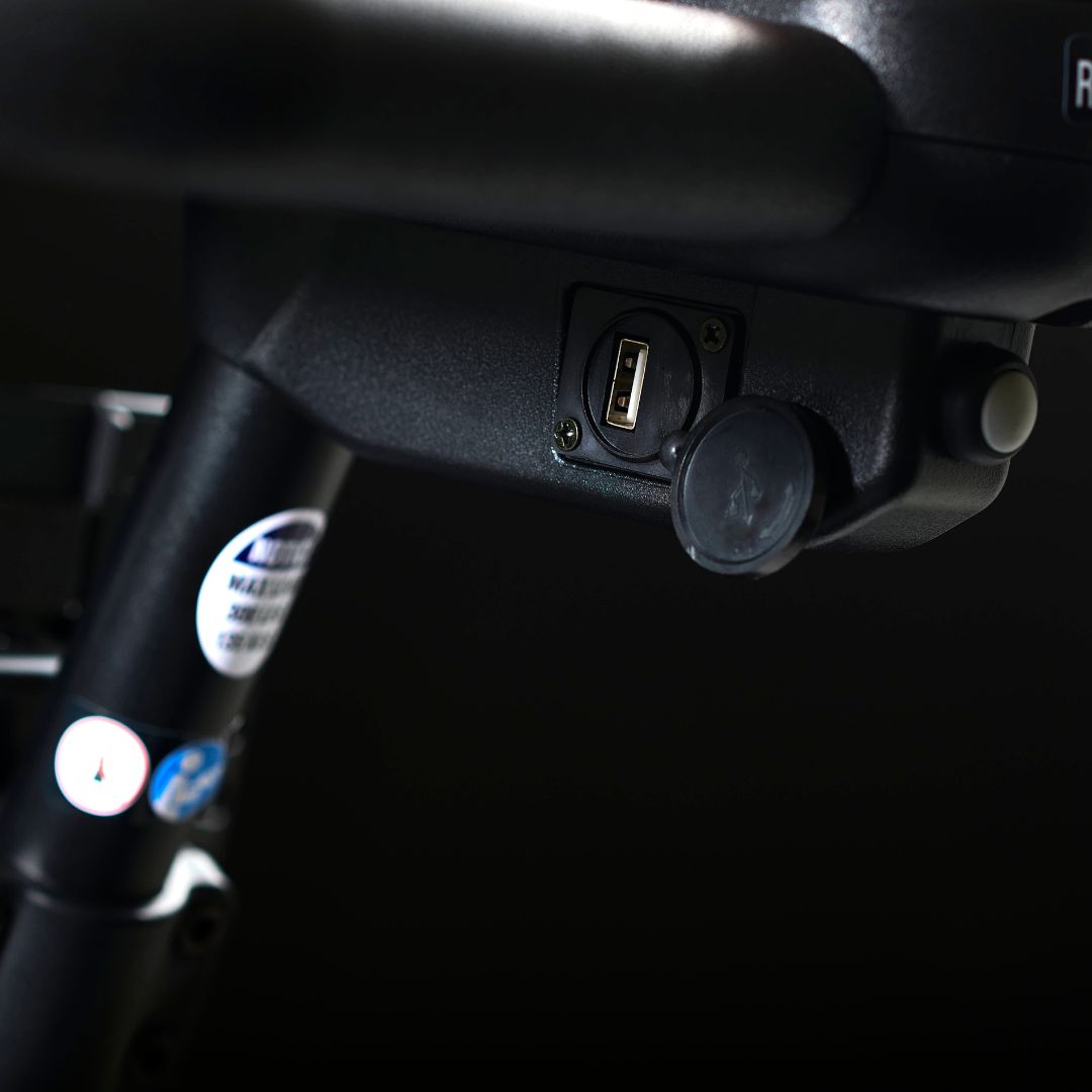 Close-up of the Golden Buzzaround XL mobility scooter USB charging port located under the control panel.