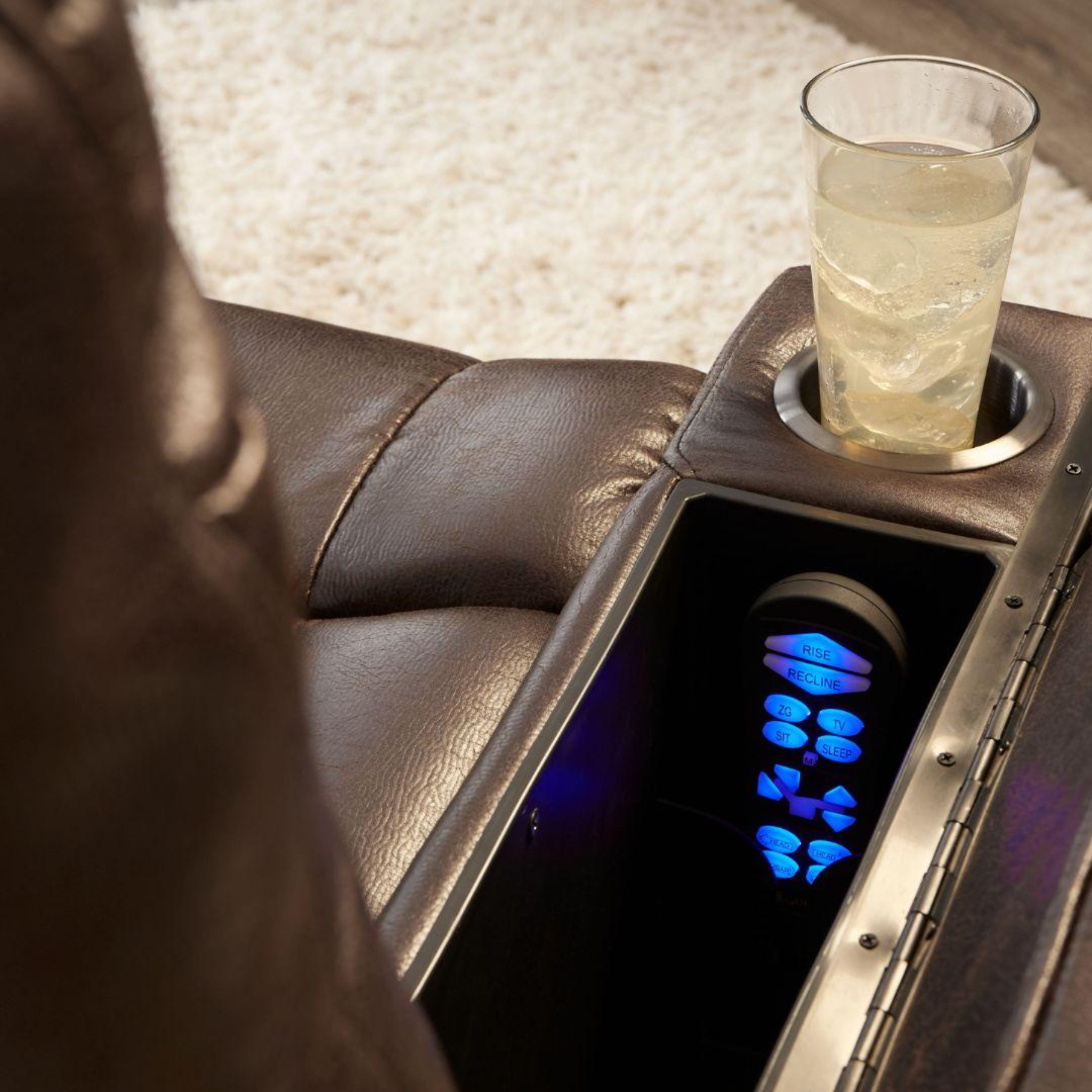 Close-up of Golden PR442 lift chair arm showing storage compartment, backlit remote, and cup holder.