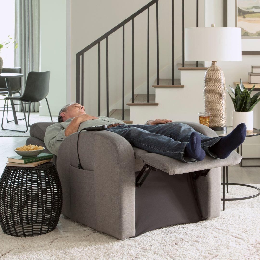 Man relaxing in a Golden PR764 Medium EZ Sleeper Slim Lift Chair with Twilight positioning