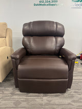 Front view of the Golden Technologies PR531-T28 Tall/Wide Lift Chair in Coffee Bean color, displayed in the Dahl Medical Supply showroom. The plush overstuffed backrest and wide seat design highlight its comfort and durability for tall and broad users.
