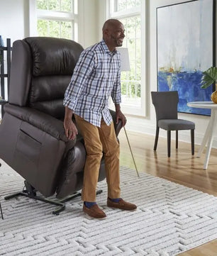 Person using the lift function on a Golden PR766 EZ Sleeper Lift Chair with Twilight 