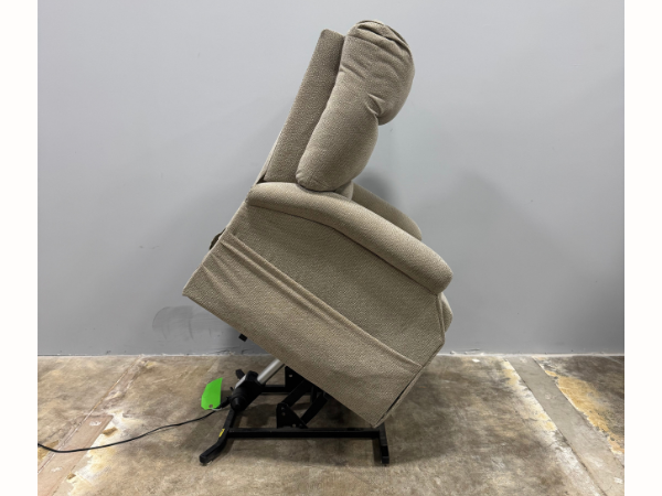 Side view of a used Pride CL20 power lift chair in the fully raised lift position, showing the chair assisting with standing and the sturdy lift mechanism underneath.