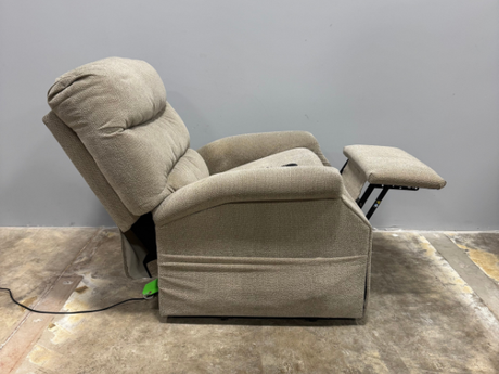 Side profile of a used Pride CL20 lift chair reclined with the footrest extended, demonstrating the chair’s reclining function and supportive seating design.