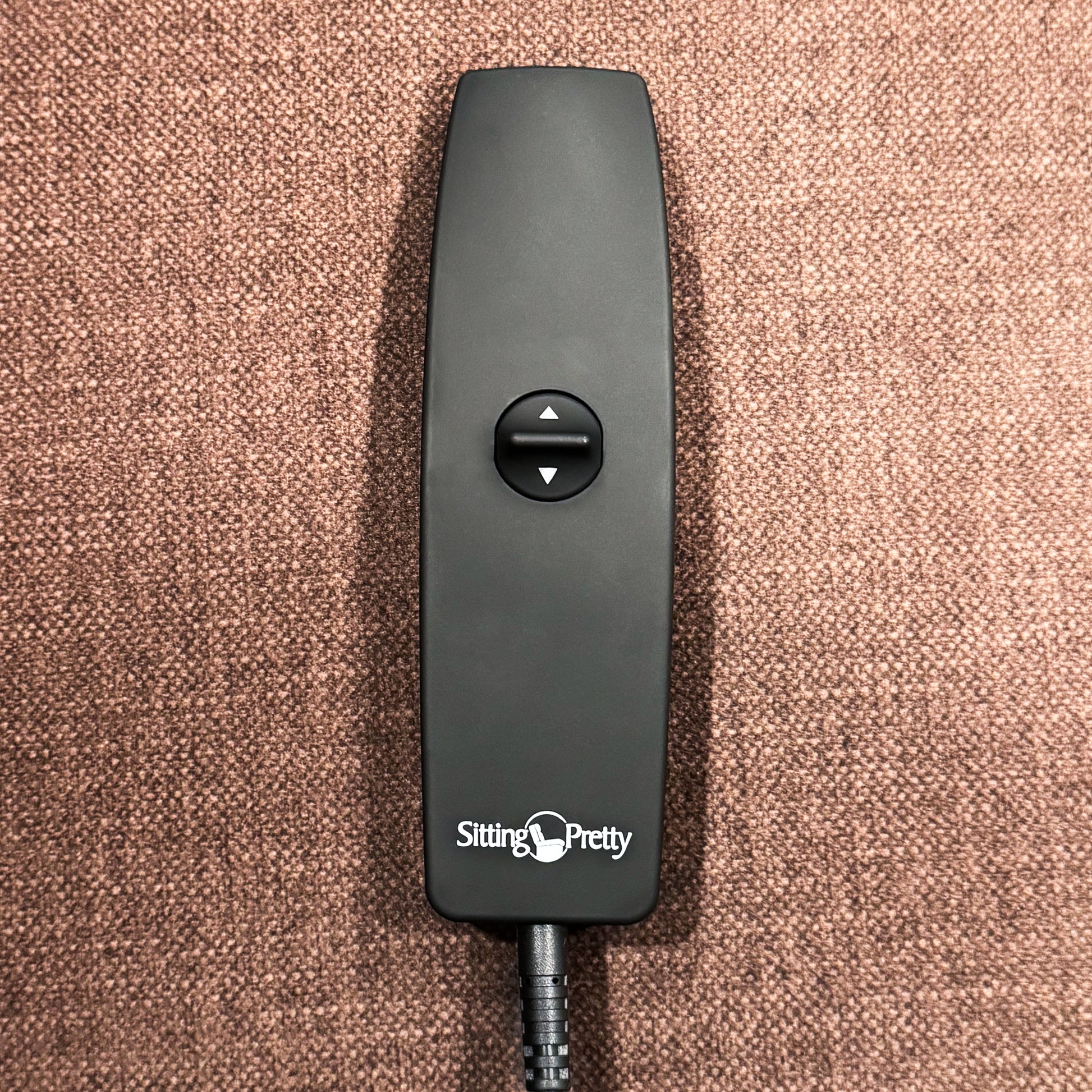 A close-up of the simple one-touch toggle remote that controls the smooth upward lift and reclining functions.