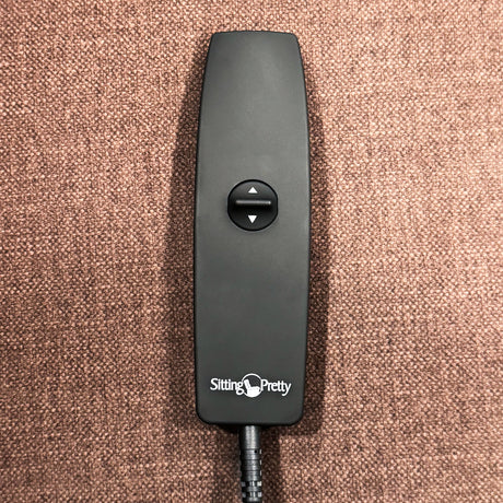 A close-up of the simple one-touch toggle remote that controls the smooth upward lift and reclining functions.