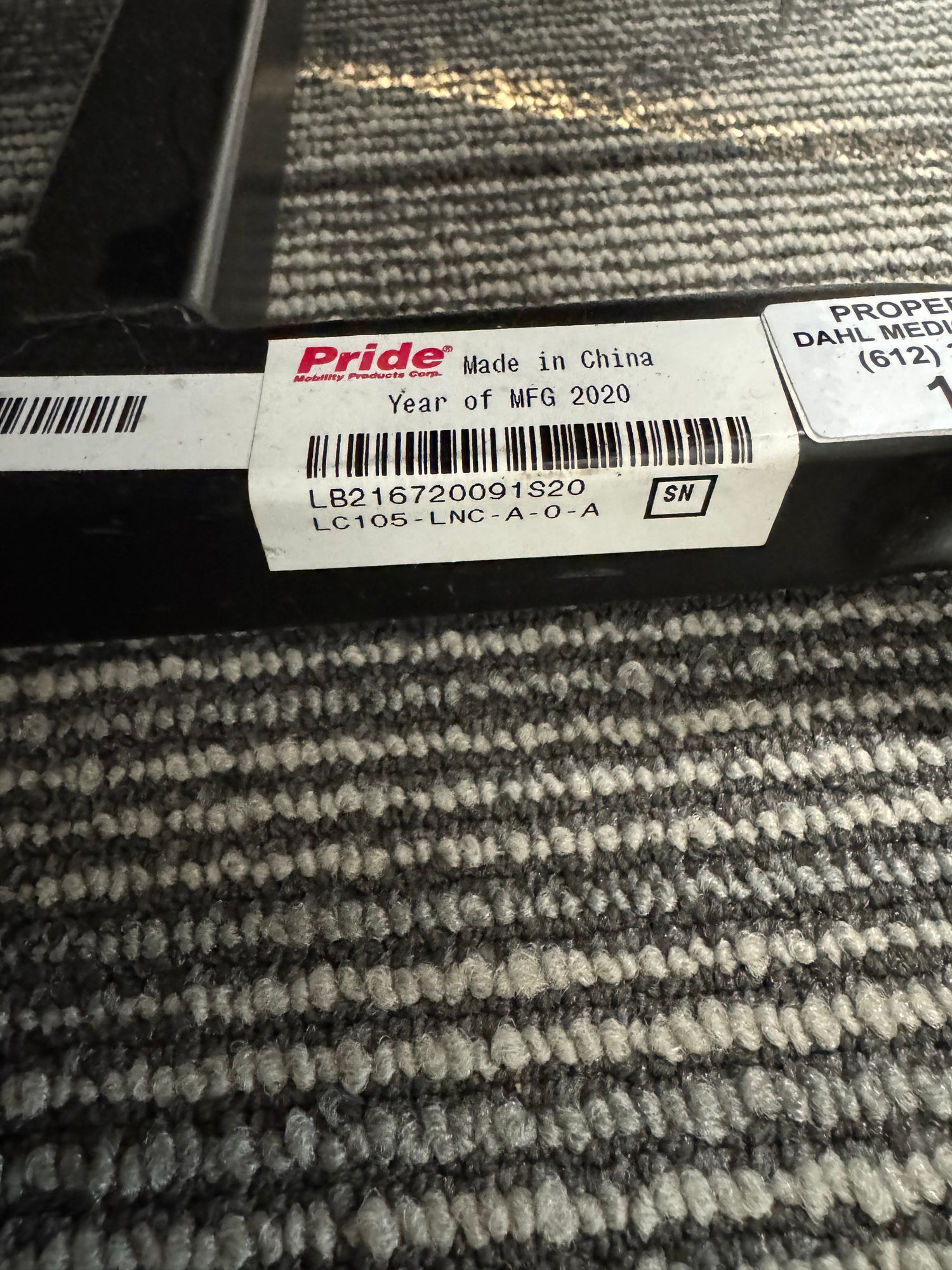 Close-up of the Pride LC-105 lift chair serial and model label showing model number LC105-LNC-A-O-A