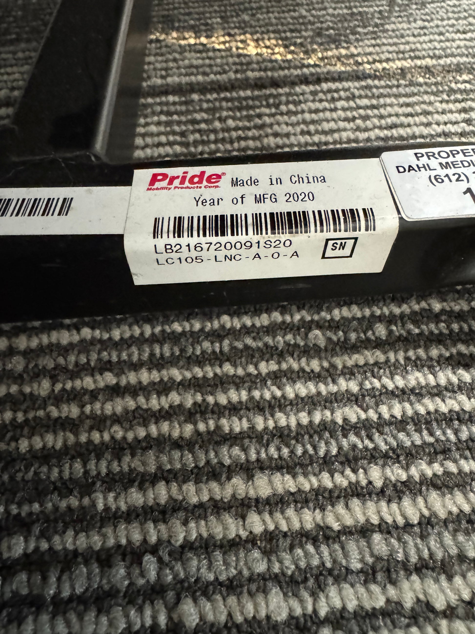 Close-up of the Pride LC-105 lift chair serial and model label showing model number LC105-LNC-A-O-A