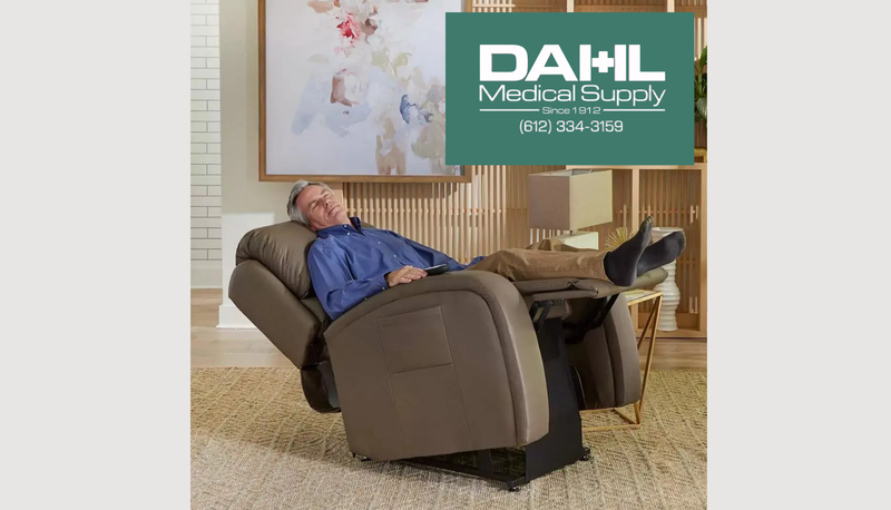 Man fully reclined in an infinite position lift chair with legs elevated for comfort and rest.