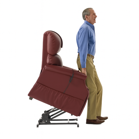 Man using a red reclining lift chair that tilts forward to assist him in standing, showing the safety and comfort features available with Dahl Medical Supply’s lift chair rentals.