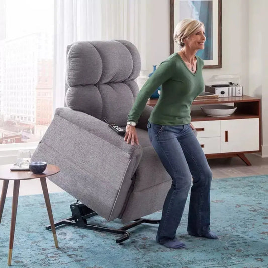 Women standing up in a grey lift chair