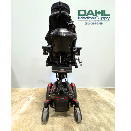 Rear view of a used Pride Edge® 3 Stretto iLevel power wheelchair showing the compact narrow base, iLevel lift mechanism, rear lighting, and mid-wheel drive configuration.
