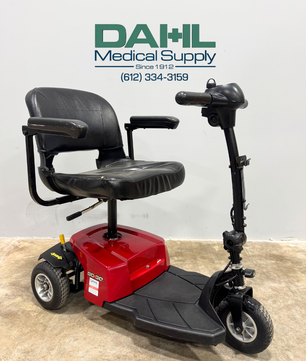 Angled view of a used Pride Go-Go ES 3-wheel mobility scooter showing the front tiller, padded seat, and stable three-wheel design, displayed at Dahl Medical Supply.