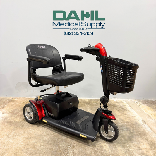 Angled front view of a used Pride Go Go Elite Traveller Plus 3-wheel mobility scooter featuring a padded seat, front basket, and easy-to-use tiller controls.