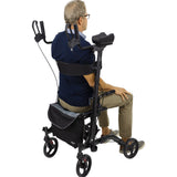 Senior man sitting on the Vive Upright Rollator Walker shown from the back, highlighting padded backrest, storage bag, and lightweight aluminum frame with 8-inch wheels – available at Dahl Medical Supply for $225.