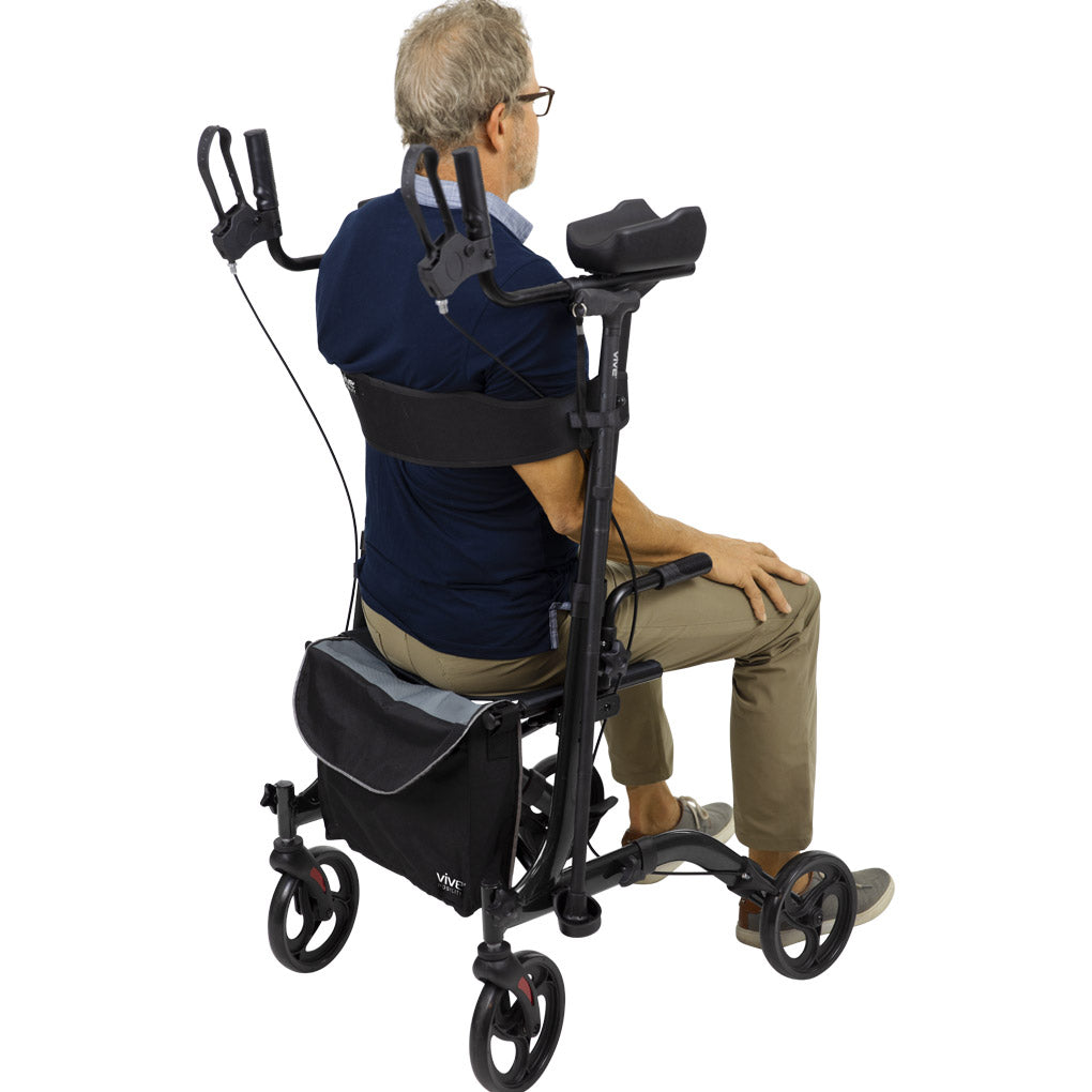 Senior man sitting on the Vive Upright Rollator Walker shown from the back, highlighting padded backrest, storage bag, and lightweight aluminum frame with 8-inch wheels – available at Dahl Medical Supply for $225.
