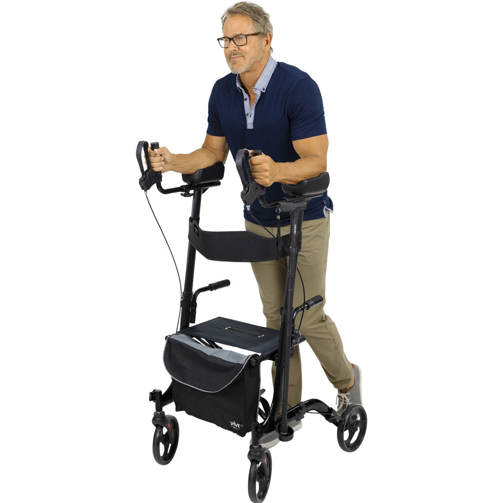 Older man walking with the Vive Upright Rollator Walker, featuring padded armrests, ergonomic hand grips, storage bag, and large 8-inch wheels for indoor and outdoor mobility – available at Dahl Medical Supply for $225.