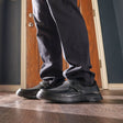 Man wearing the Anodyne No. 52 black diabetic shoe while standing on a hardwood floor, showcasing its supportive fit, sleek leather design, and orthopedic comfort for daily wear.